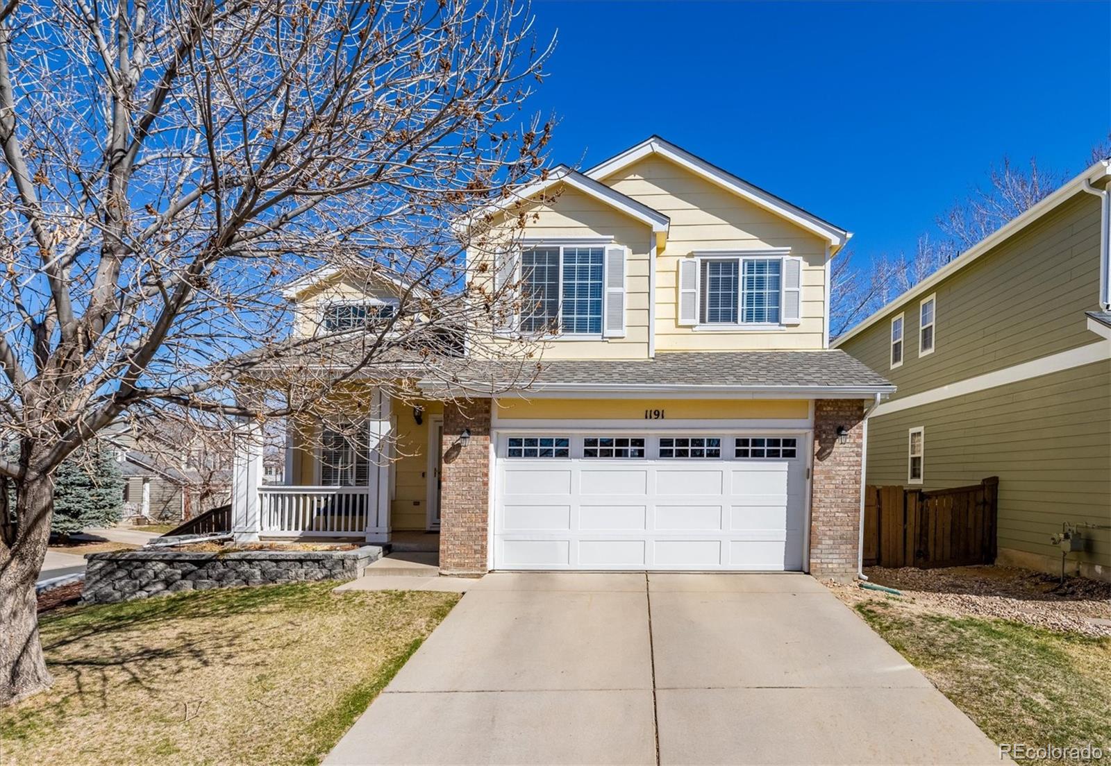 1191 Riddlewood Lane Highlands Ranch, CO 80129 - Photo 1 of 33 a front view of a house with a yard and garage