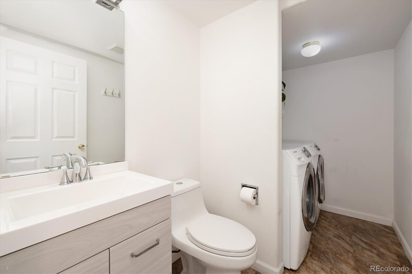 1191 Riddlewood Lane Highlands Ranch, CO 80129 - Photo 16 of 33 a bathroom with a sink a toilet and mirror