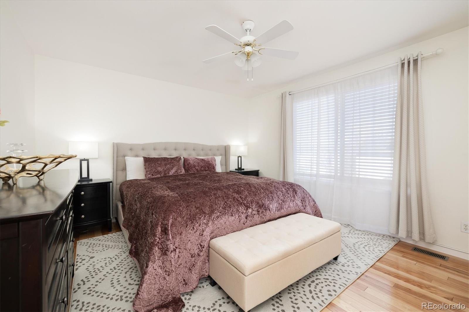 1191 Riddlewood Lane Highlands Ranch, CO 80129 - Photo 17 of 33 a spacious bedroom with a bed and a window