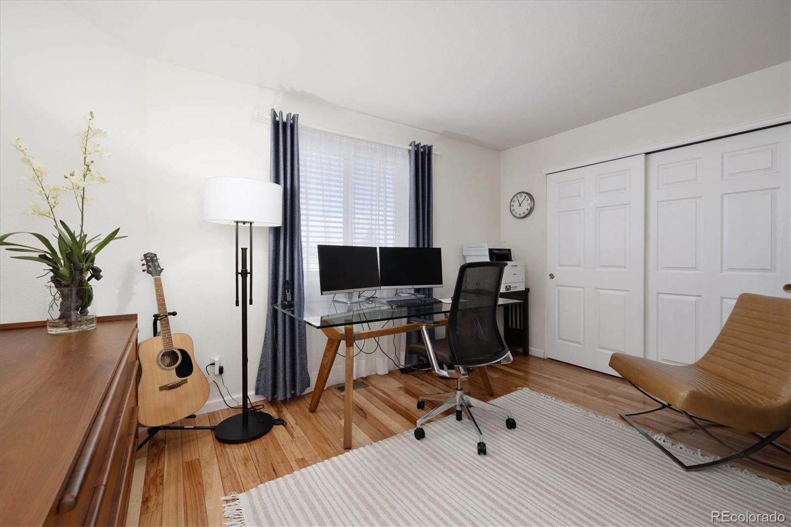 1191 Riddlewood Lane Highlands Ranch, CO 80129 - Photo 22 of 33 a view of a workspace with furniture and wooden floor