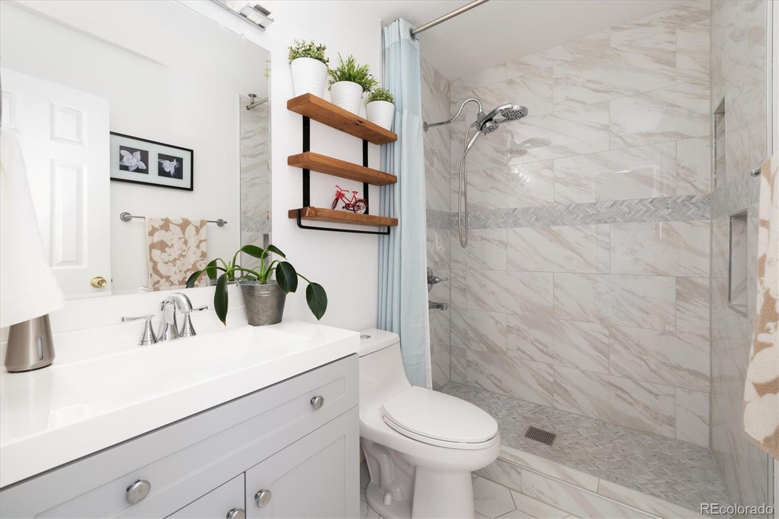 1191 Riddlewood Lane Highlands Ranch, CO 80129 - Photo 24 of 33 a bathroom with a sink mirror vanity and toilet