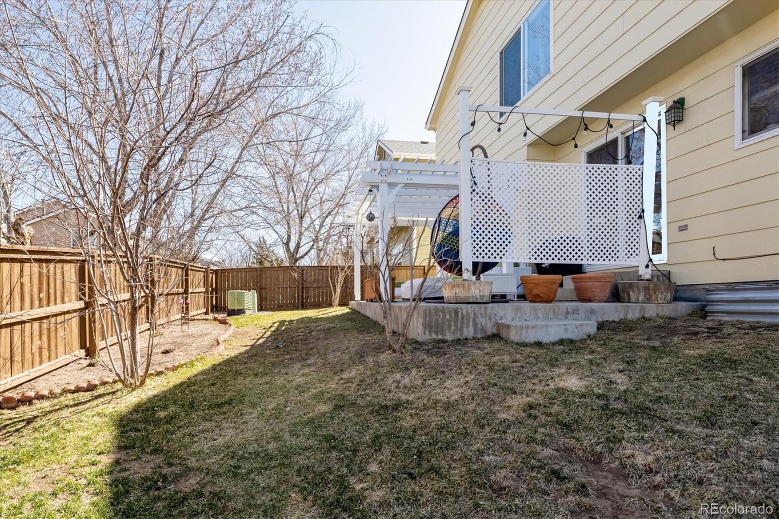 1191 Riddlewood Lane Highlands Ranch, CO 80129 - Photo 27 of 33 a view of a house with a yard
