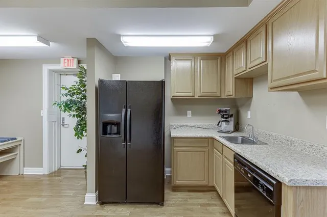 a kitchen with stainless steel appliances granite countertop a refrigerator and a stove