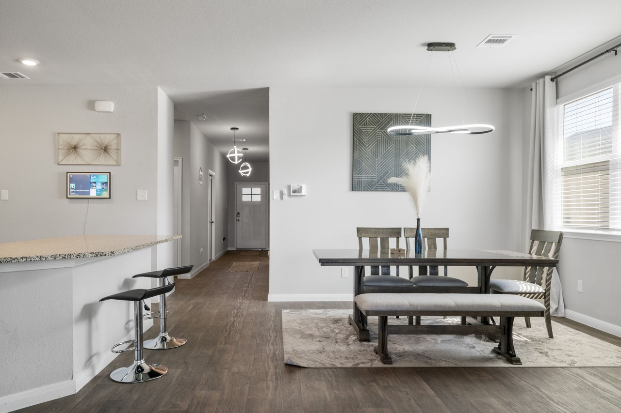 212 Apache Plum Drive Kyle, TX 78640 - Photo 11 of 21 Dining area with dark wood-style floors and baseboards
