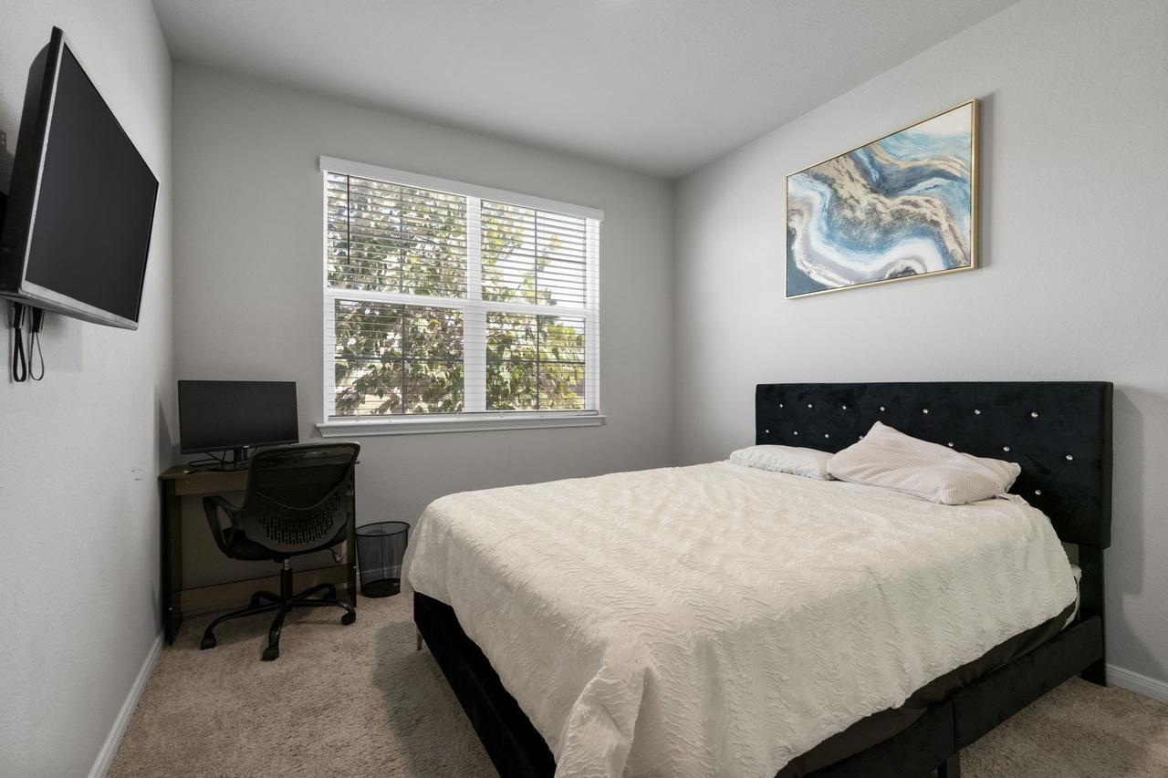 212 Apache Plum Drive Kyle, TX 78640 - Photo 14 of 21 Bedroom featuring an office area and light carpet