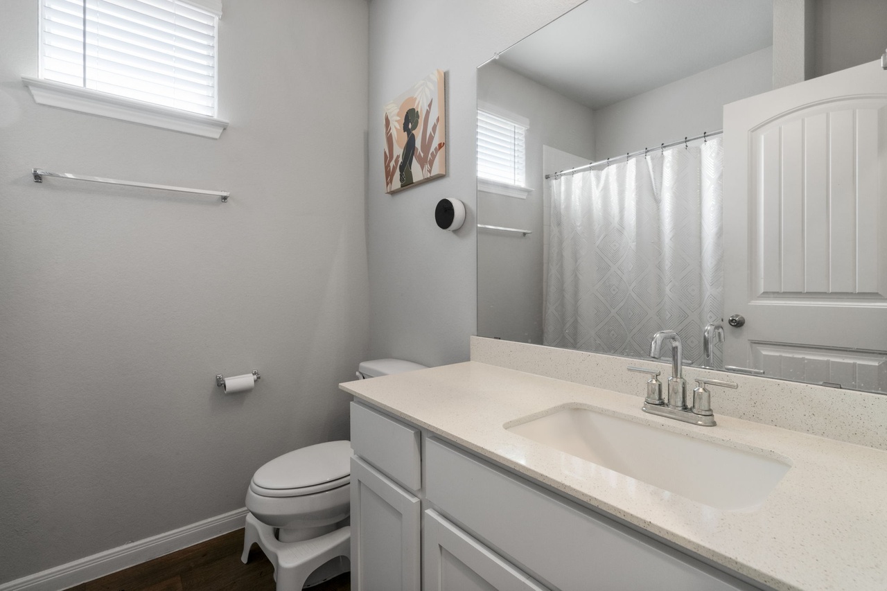 212 Apache Plum Drive Kyle, TX 78640 - Photo 15 of 21 Full bath with vanity, a shower with shower curtain, and dark wood-type flooring