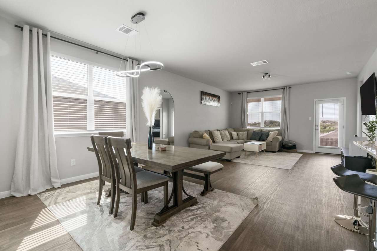 212 Apache Plum Drive Kyle, TX 78640 - Photo 3 of 21 Dining space featuring arched walkways and wood finished floors