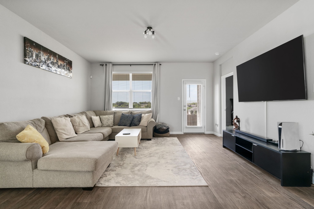 212 Apache Plum Drive Kyle, TX 78640 - Photo 4 of 21 Living room featuring wood finished floors and baseboards