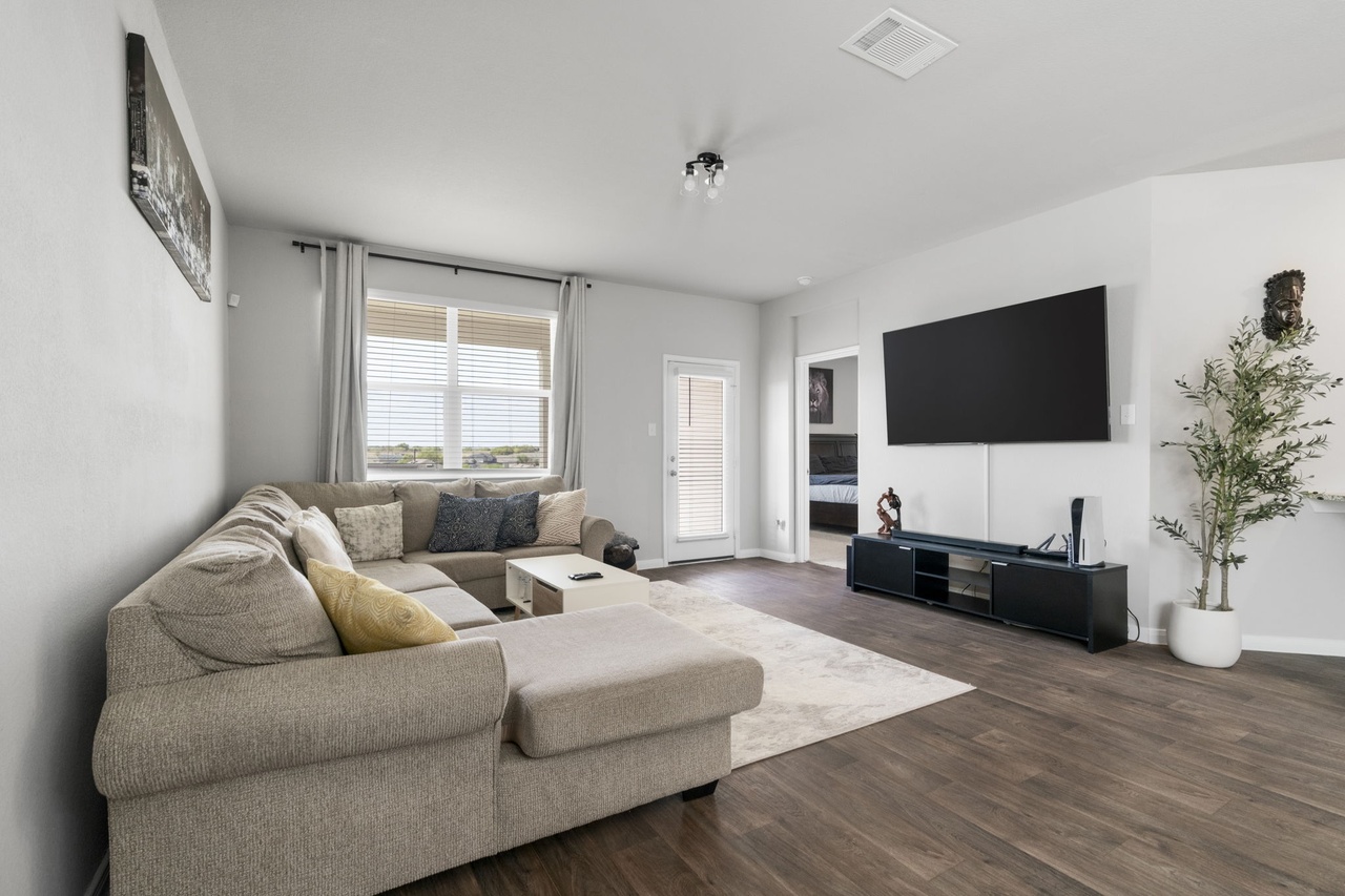 212 Apache Plum Drive Kyle, TX 78640 - Photo 9 of 21 Living room with dark wood-style flooring and baseboards