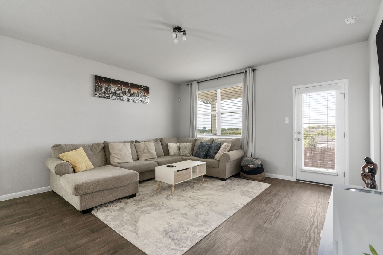 212 Apache Plum Drive Kyle, TX 78640 - Photo 10 of 21 Living room featuring wood finished floors and baseboards