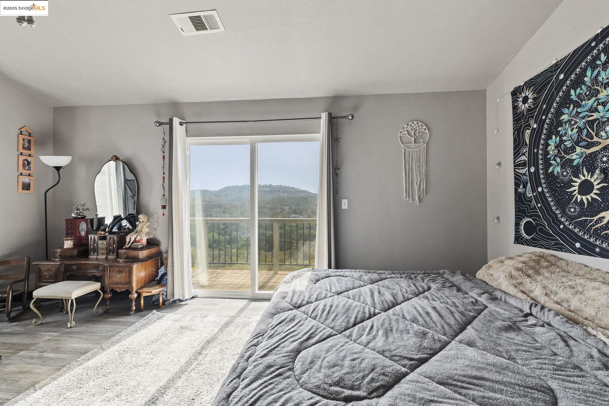 20588 Upper Hillview Drive Sonora, CA 95370 - Photo 12 of 42 a bedroom with a bed and a large window