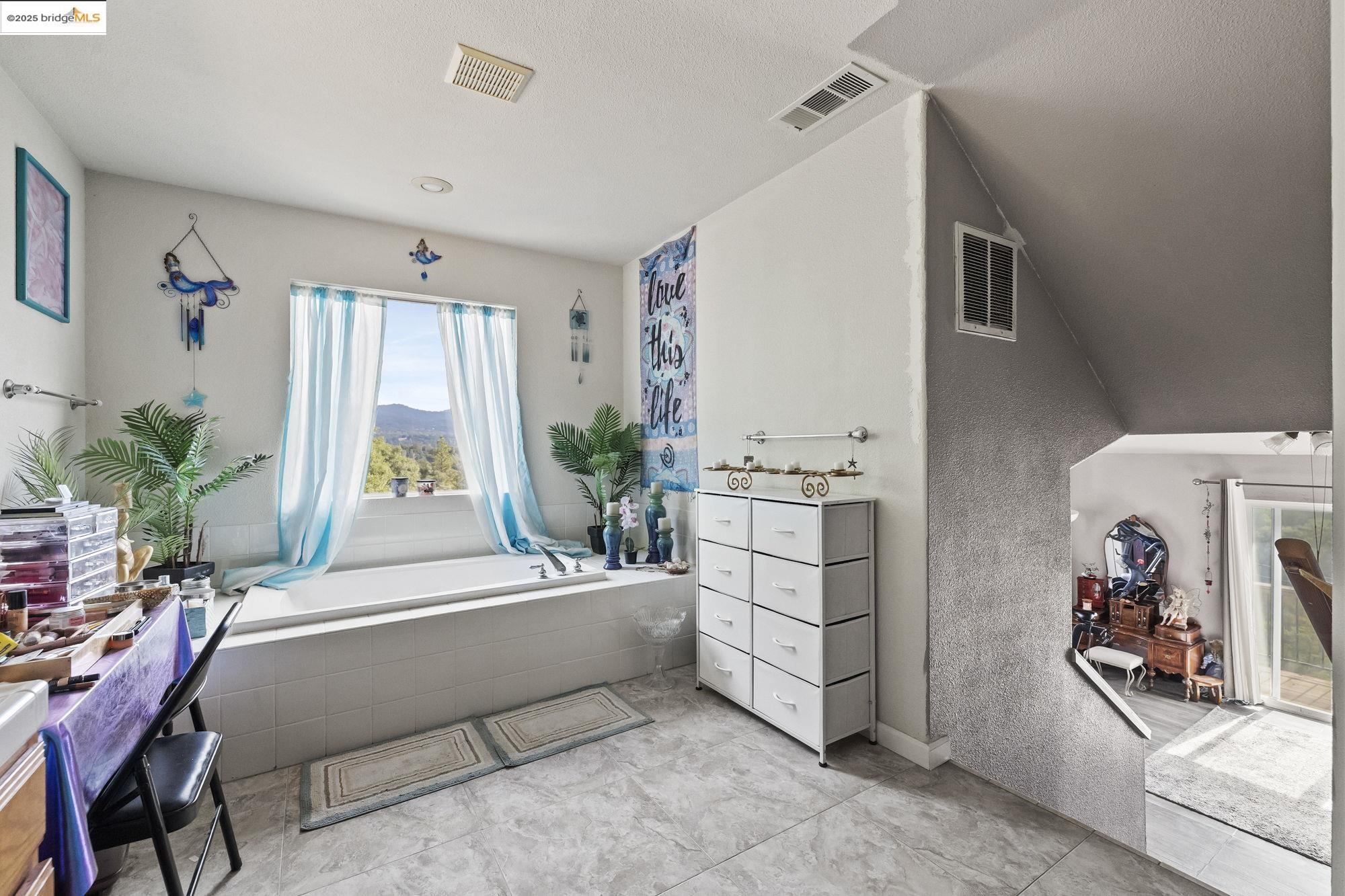 20588 Upper Hillview Drive Sonora, CA 95370 - Photo 16 of 42 a bedroom with furniture and a bed