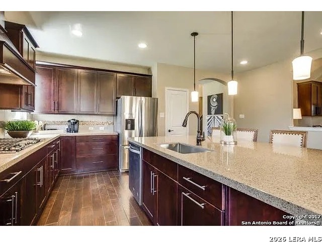 119 Aberdeen Boerne, TX 78015 - Photo 2 of 10 a kitchen with stainless steel appliances granite countertop a sink a stove and a wooden floors