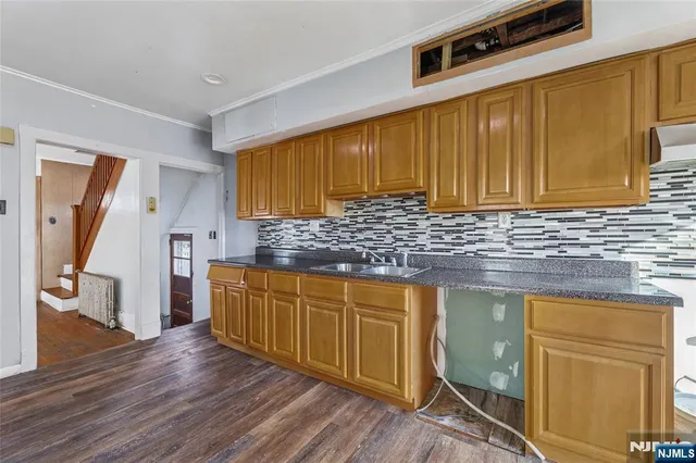 a kitchen with wooden cabinets and a sink