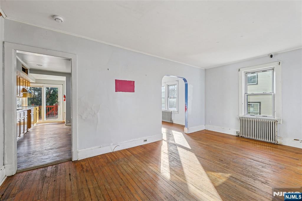 109 Luke Avenue Bergenfield, NJ 07621 - Photo 16 of 16 an empty room with wooden floor and windows