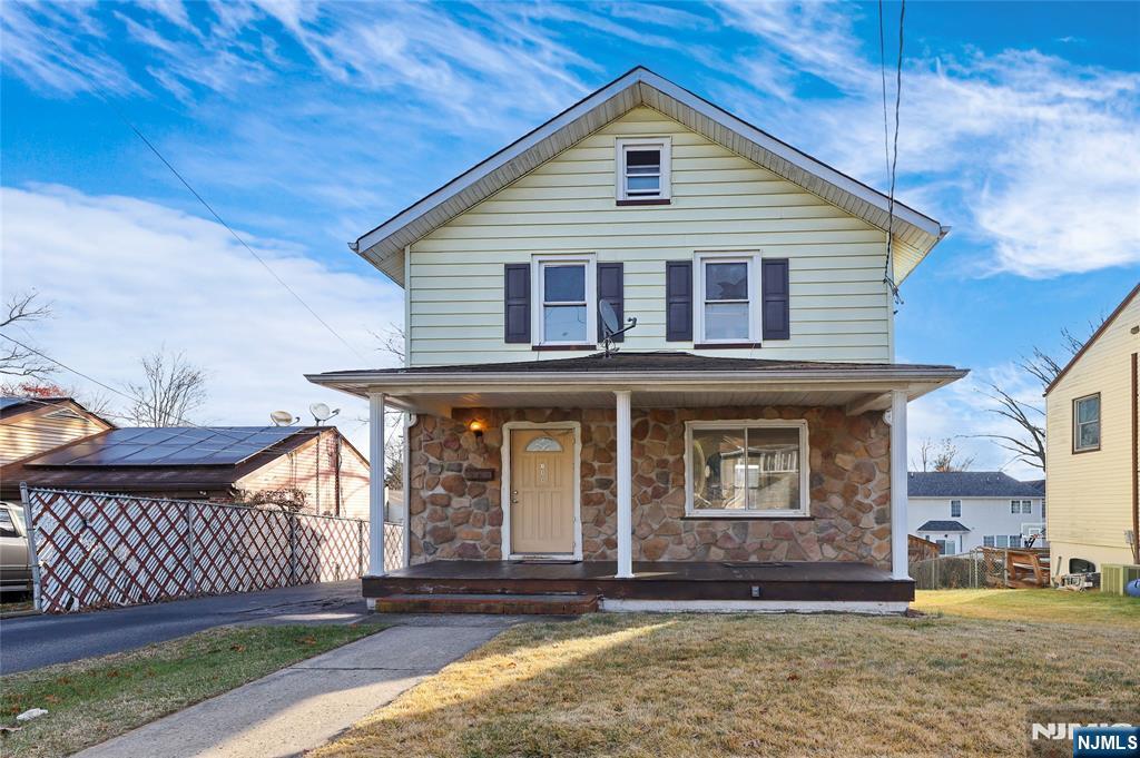 109 Luke Avenue Bergenfield, NJ 07621 - Photo 5 of 16 a front view of a house with a yard