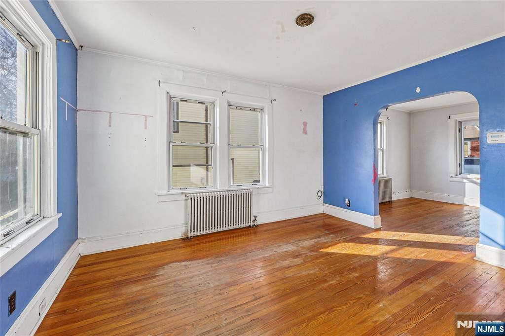 109 Luke Avenue Bergenfield, NJ 07621 - Photo 7 of 16 a view of an empty room with wooden floor and a window