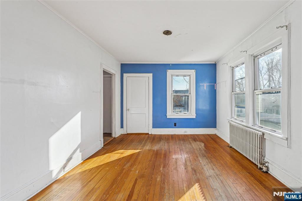 109 Luke Avenue Bergenfield, NJ 07621 - Photo 8 of 16 a view of a bedroom with wooden floor and windows