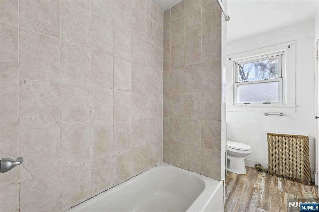 109 Luke Avenue Bergenfield, NJ 07621 - Photo 9 of 16 a bathroom with a white toilet and a shower