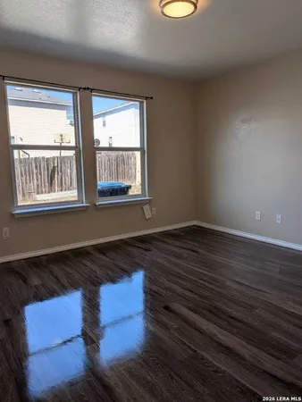 a room with wooden floor and a window