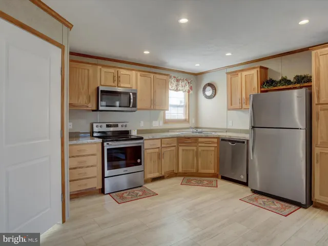 a kitchen with a refrigerator stove and microwave