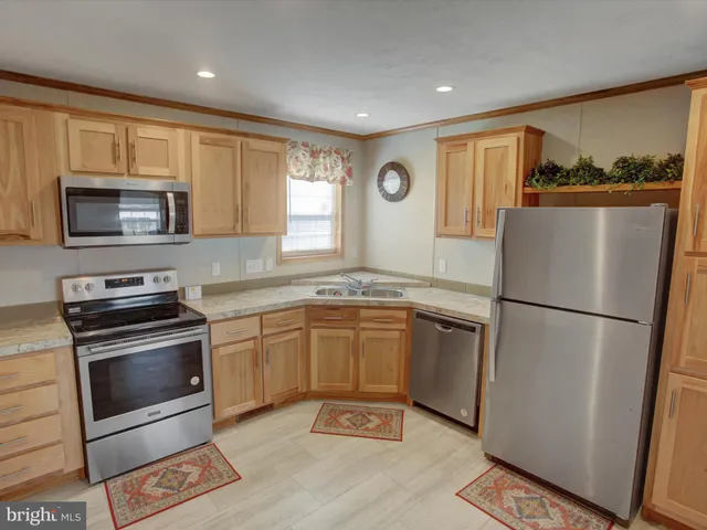 a view of a room with a fan and wooden floor