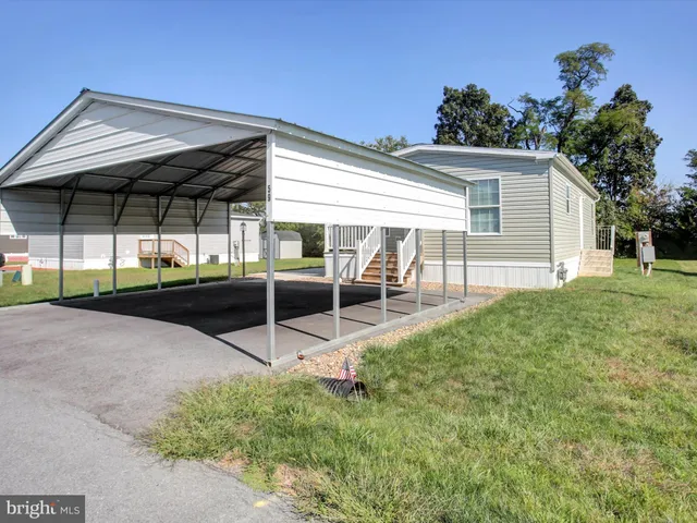 a view of a backyard with table and chairs under an umbrella