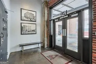 a lobby with furniture and floor to ceiling window