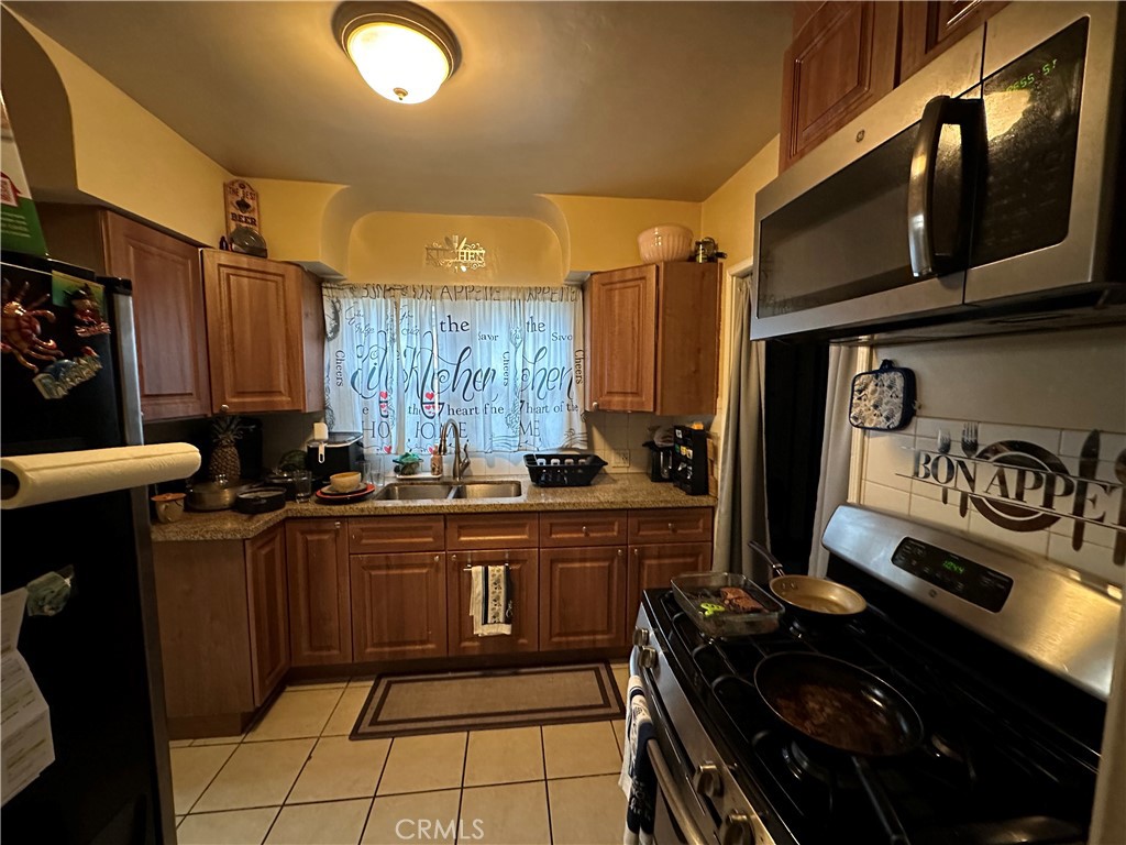 4056 Creed Avenue Los Angeles, CA 90008 - Photo 5 of 13 a kitchen with granite countertop a stove and a sink
