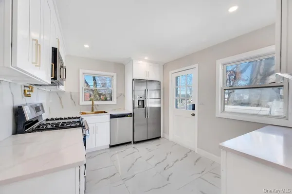 a kitchen with a refrigerator and a stove top oven