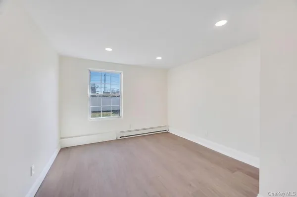 an empty room with a empty space and window