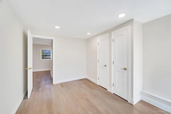 a view of hallway with wooden floor