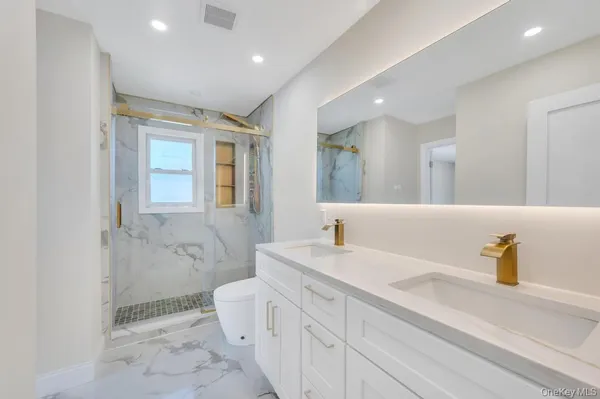 a spacious bathroom with a sink and a mirror