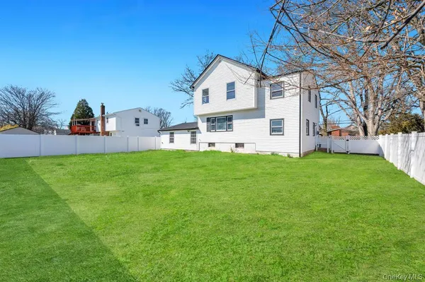 a view of a house with a yard and sitting area