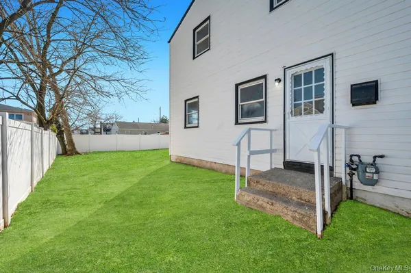 a view of a bedroom with backyard and wooden fence