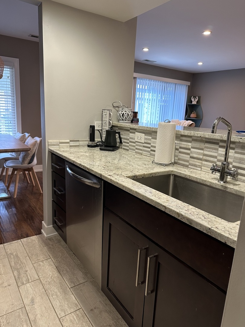 9830 Sayre Avenue, Unit 13 Chicago Ridge, IL 60415 - Photo 10 of 34 a kitchen with stainless steel appliances granite countertop a sink stove and cabinets