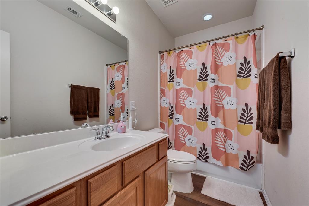 508 Elmgrove Trail Forney, TX 75126 - Photo 17 of 32 a bathroom with a sink and mirror with toilet