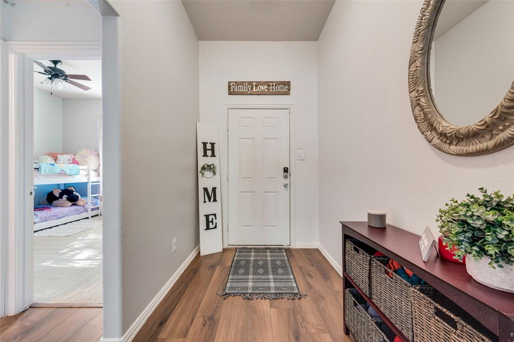 508 Elmgrove Trail Forney, TX 75126 - Photo 6 of 32 a view of a hallway view with wooden floor and staircase