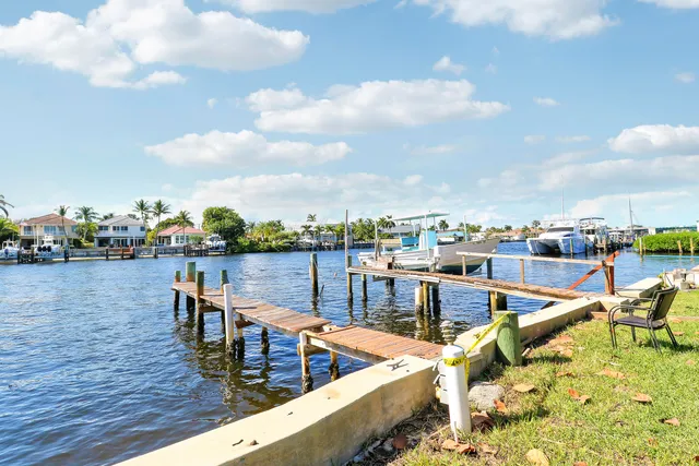 a view of a lake with couches chairs