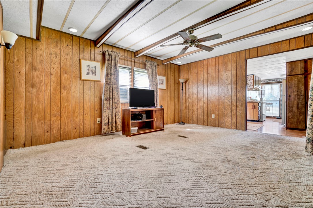 1504 Park Ridge Drive Seneca, SC 29672 - Photo 14 of 16 Classic wood paneling and textured carpeting define this cozy, light-filled living space.