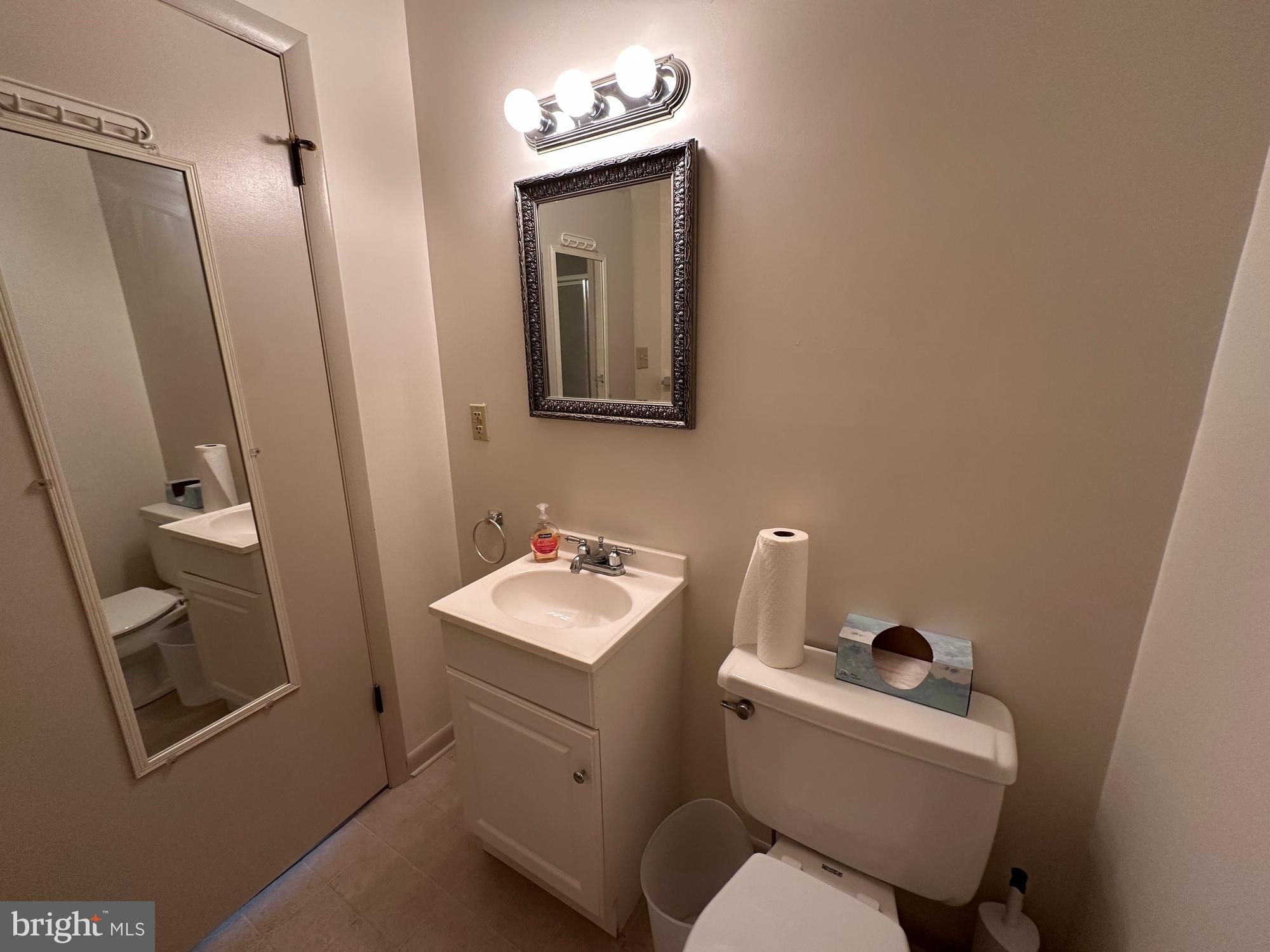 3 Delaware Avenue Delmar, DE 19940 - Photo 9 of 10 a bathroom with a toilet sink and mirror