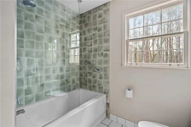 a bathroom with a bathtub and window