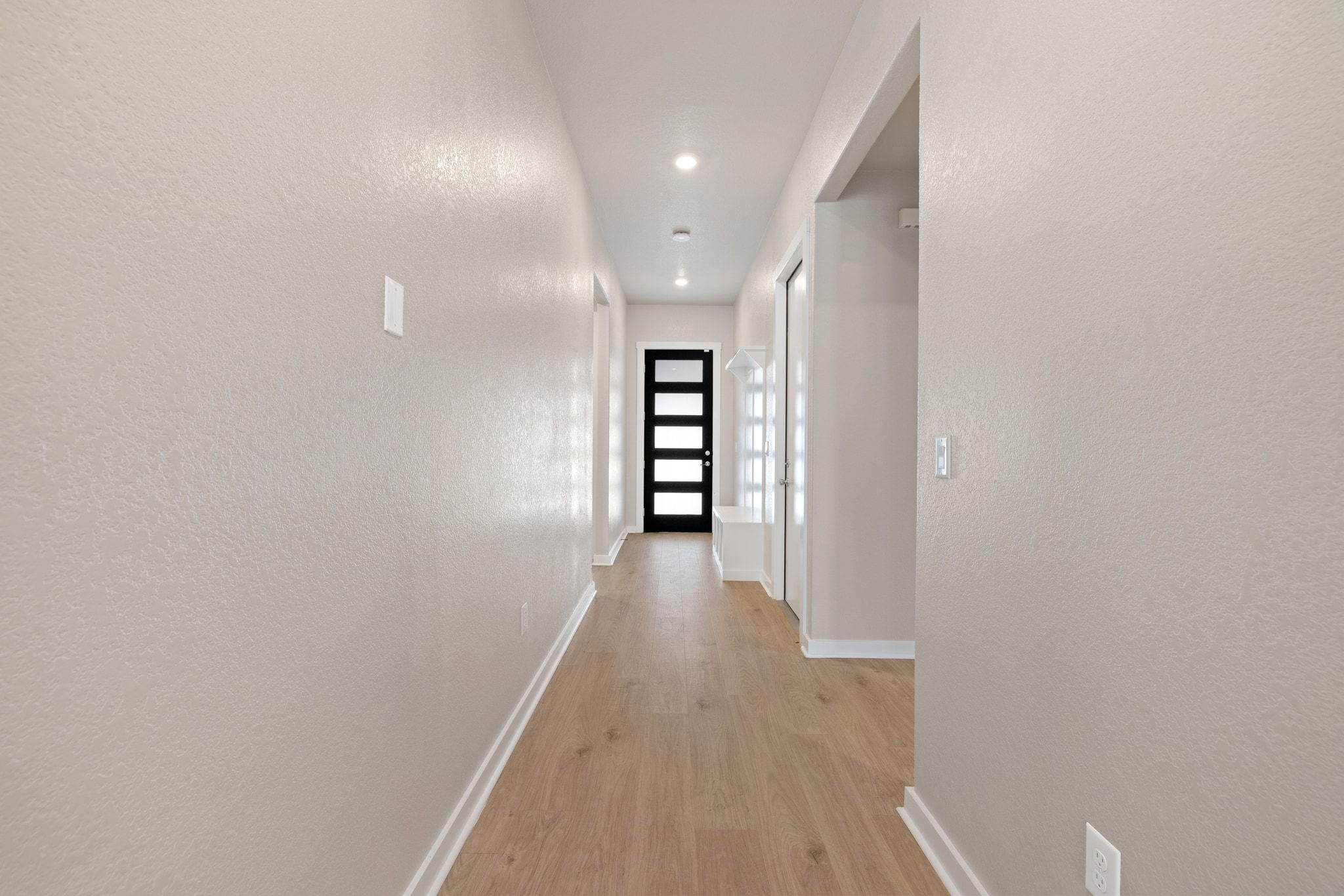 309 Barton Run Drive Georgetown, TX 78628 - Photo 11 of 35 Hall with a textured wall, light wood-type flooring, and recessed lighting