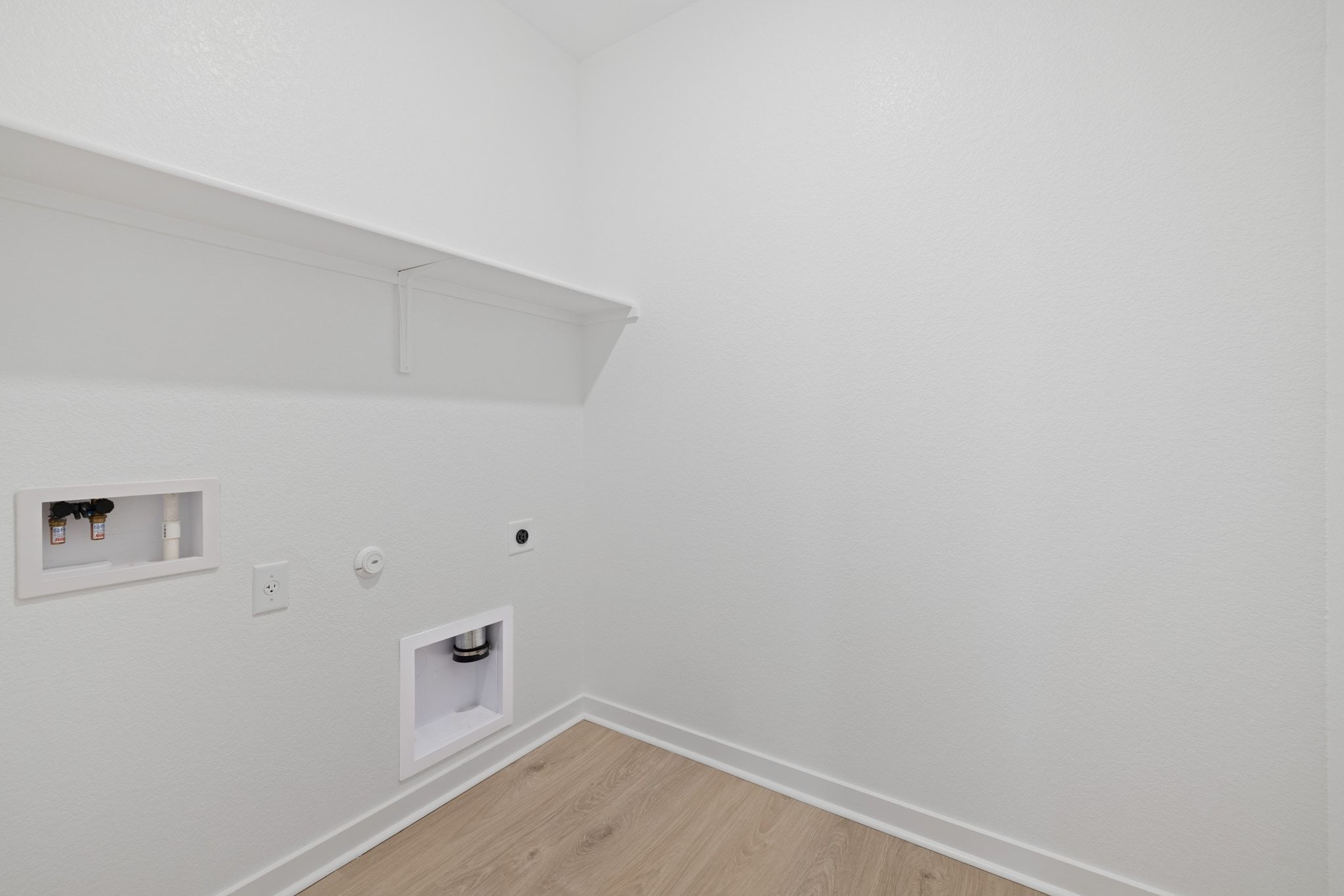 309 Barton Run Drive Georgetown, TX 78628 - Photo 22 of 35 Laundry area with gas dryer hookup, light wood-type flooring, washer hookup, and electric dryer hookup