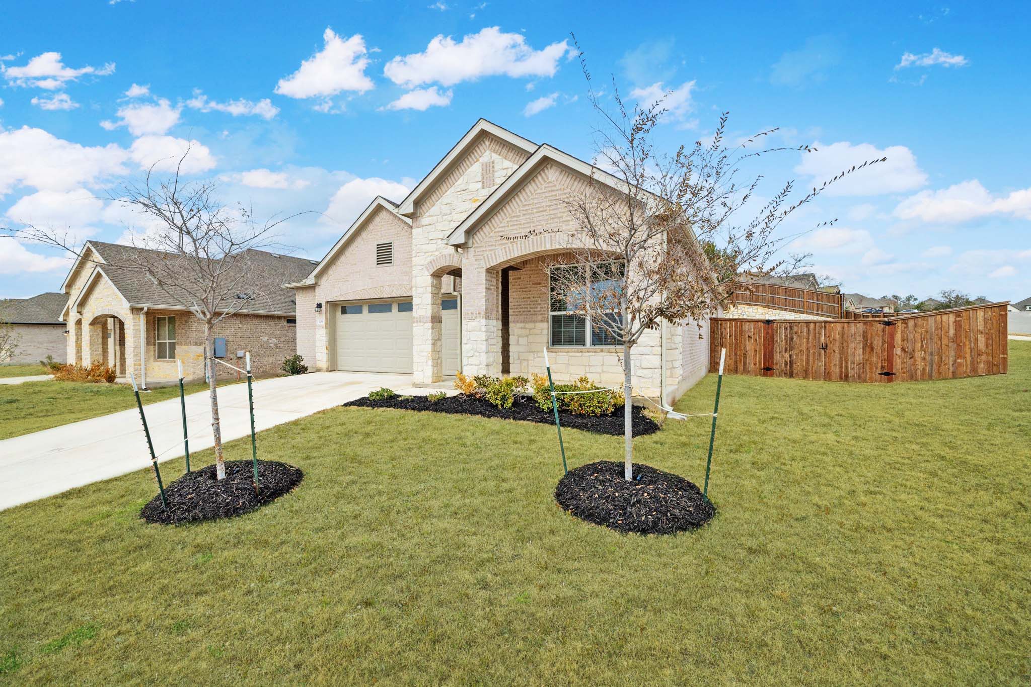 309 Barton Run Drive Georgetown, TX 78628 - Photo 3 of 35 View of front of house with brick siding, concrete driveway, a garage, and stone siding