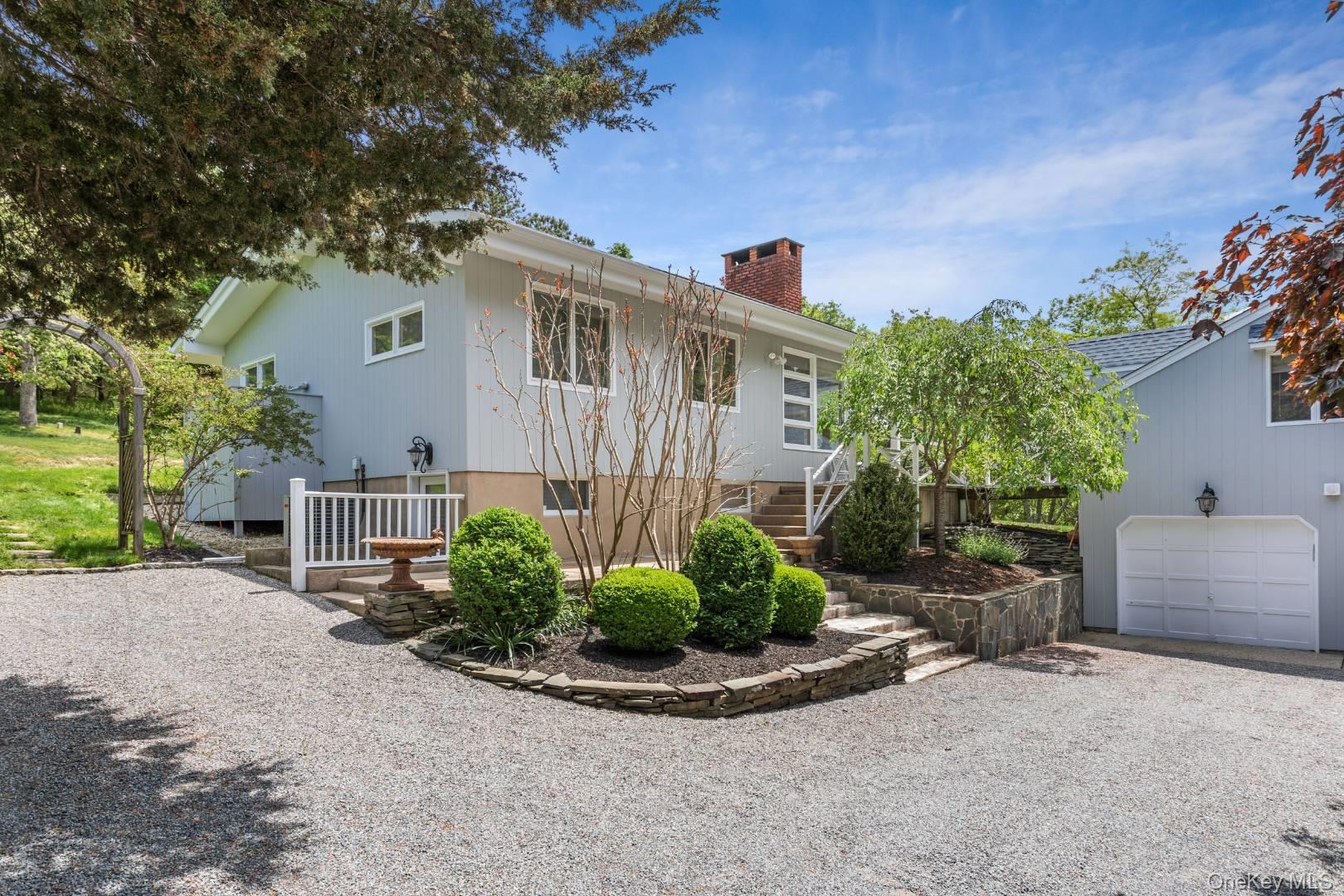 16 South Beach Road Southampton, NY 11968 - Photo 1 of 14 View of front of house with stairway, driveway, a chimney, and a garage