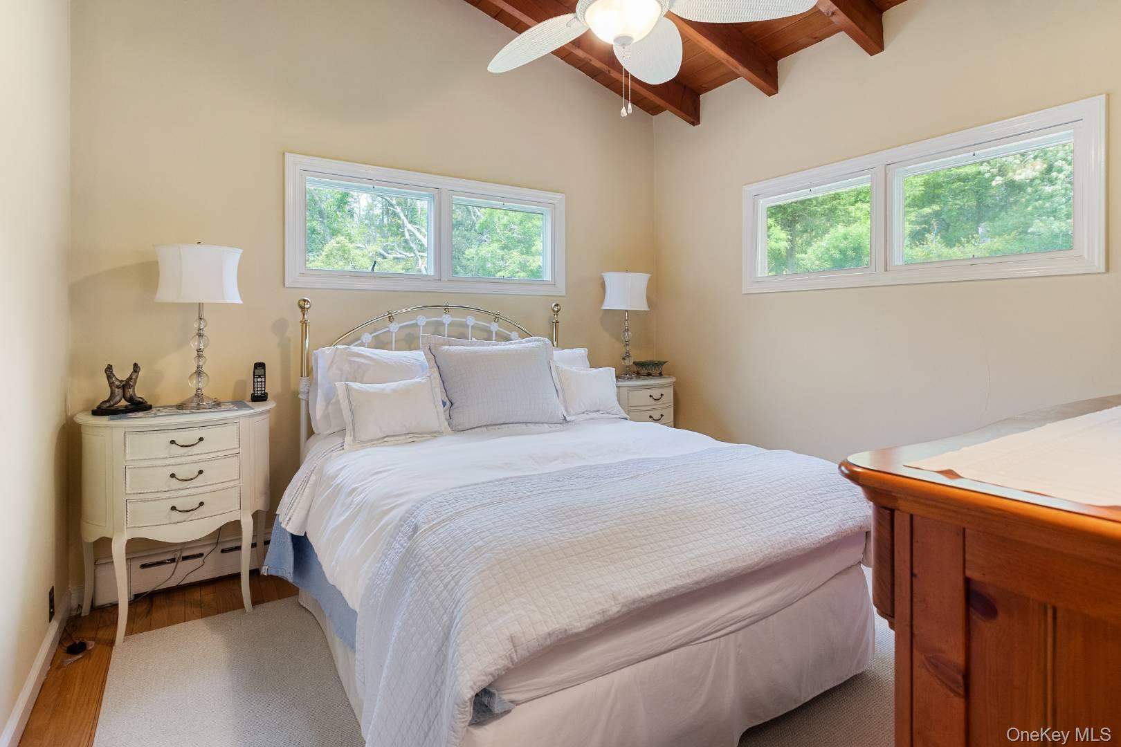 16 South Beach Road Southampton, NY 11968 - Photo 12 of 14 Bedroom with wooden ceiling, wood finished floors, ceiling fan, and a baseboard radiator