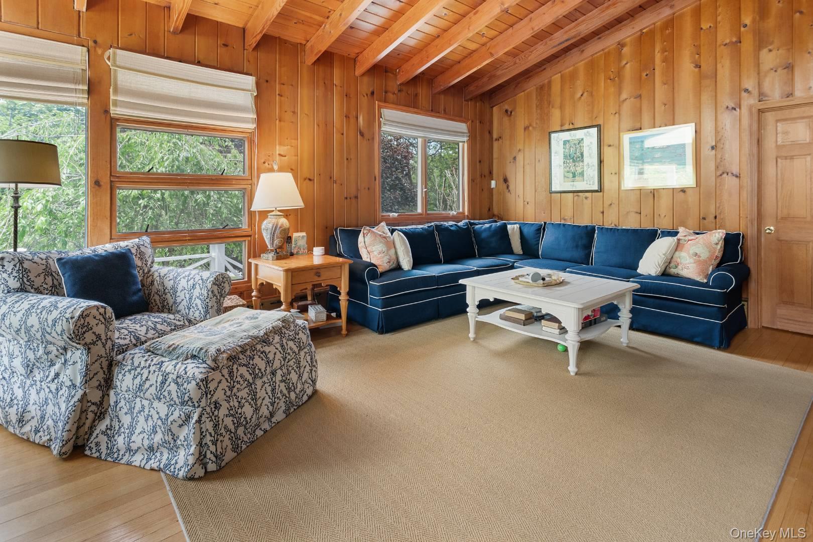 16 South Beach Road Southampton, NY 11968 - Photo 4 of 14 Living room with a wooden ceiling with exposed beams, wood-type flooring, and wood walls