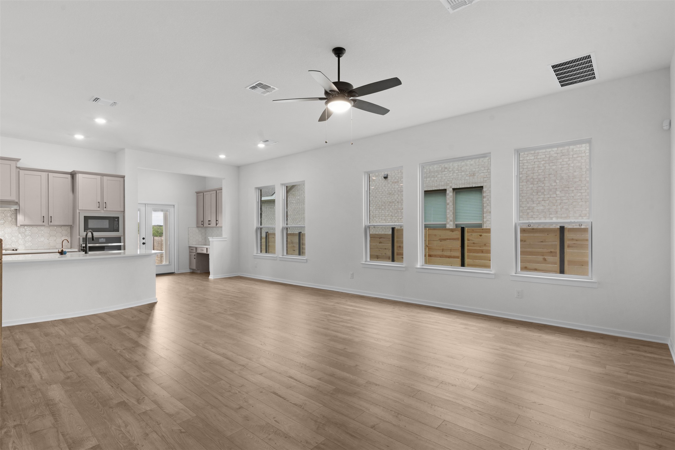 405 Raleigh Drive Georgetown, TX 78633 - Photo 5 of 27 Unfurnished living room featuring dark wood finished floors, ceiling fan, and recessed lighting
