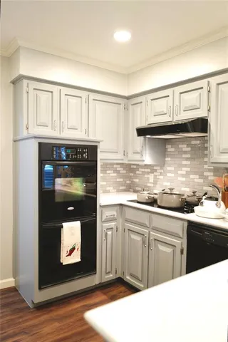 a kitchen with stainless steel appliances granite countertop a stove and cabinets